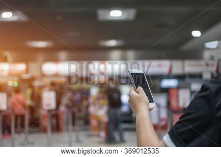 Checkin Online Or Booking By Smartphone Concept: Hands Using Smart Phone Apps In Airport Forcheck In