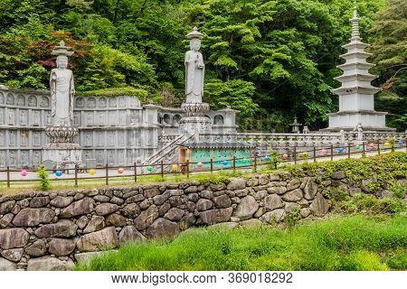 Haeinsa-gil, South Korea; May 26, 2020: Two Statues Of Standing Buddha And Six Story Pagoda In Mount