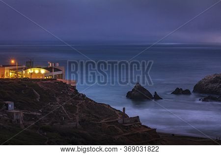 Ruins Of The Sutro Baths At Lands End On Ocean Beach, The Cliff House In The Background In San Franc