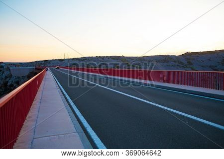 Red Bridge Over The Canyon In Croatia At Sunset. View From The Bridge To The Canyon In The Krka Nati