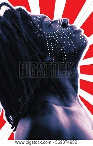 Portrait of a Sexy African man with traditional face paint, dreadlocks and meditative expression