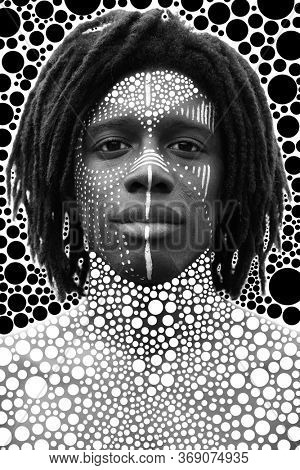 Portrait of young african man with dreadlocks and traditional face paint looking straight into the camera