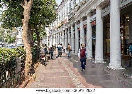 New Delhi, India - December 4, 2019: People And Classic Facades Of Columns At Connaught Place.