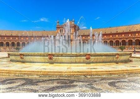 Central Fountain Of Plaza De Espana In Seville With Renaissance Building Consisting Of Arches And Co