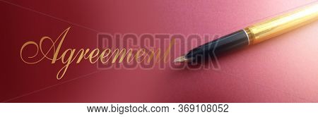 Agreemnt Word In Golden Ink And Old-fashioned Luxury Pen On Marsala Color Paper. Business Conctract 
