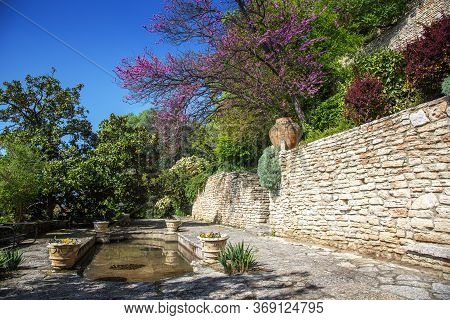 Garden With Landscaping And Stone Flower Beds.