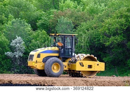 Soil Skating Rink, Road Roller Making New Highway. Heavy Industrial Machine Working On A Constructio