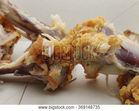 Waste Chicken Bone On A White Background Close-up, Bones In A Food Box.