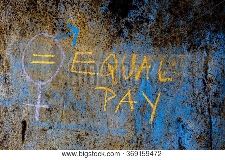 Creative Representation Of Equal Pay With A Bigender Symbol Over A Rough Wall With Written Equal Pay
