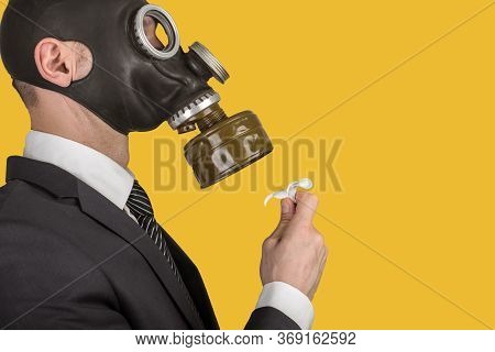 Close Up Portrait Of Man In A Protective Gas Mask With Flower