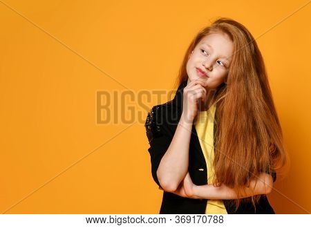 Red-haired Teenage Boy In A Black Jacket And Trousers, A Yellow T-shirt. She Thoughtfully Props Up H