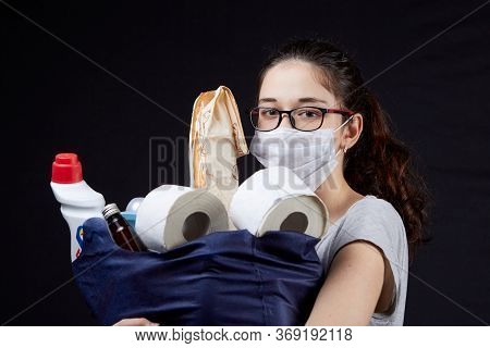 Young Woman In Protective Mask With A Bag Full Of Groceries From The Supermarket