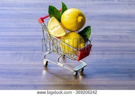 Supermarket cart carrying green leaf and lemon