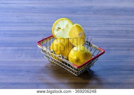 Supermarket cart carrying green leaf and lemon