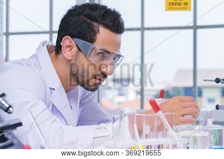 Doctor And Microbiologist With Vacuum Tubes For Samples With Covid 19 Infection Atypical Pneumonia V