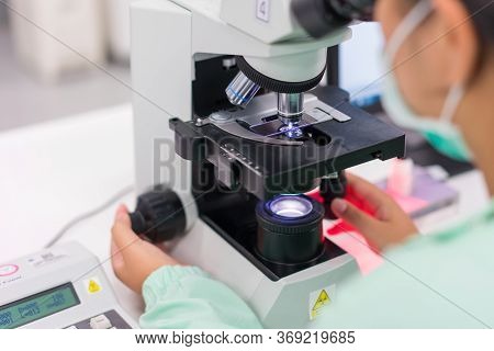 Doctor And Microbiologist With Vacuum Tubes For Samples With Covid 19 Infection Atypical Pneumonia V