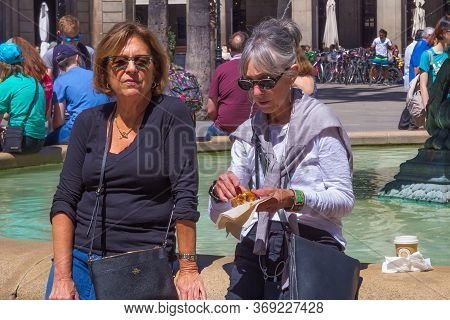 Barcelona, Spain - May 15, 2017: Unknown Elderly Women Resting Near Fountain On The Placa Reial (roy
