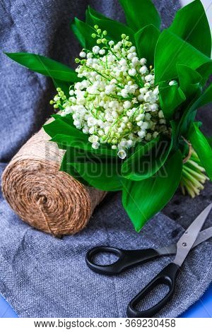 Spring Bouquet Of Lilies Of The Valley With Scissors Rope In A Flower Shop, White Flowers And Green 