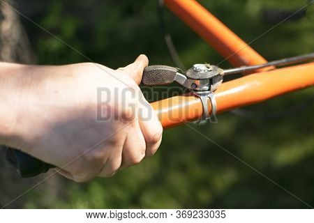Man Farmer Plows The Land With A Cultivator. Agricultural Machinery: Cultivator For Tillage In The G