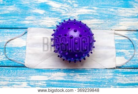 A Coronavirus Molecule Is Lying On A Medical Mask.the Concept Of Coronavrius Epidemic