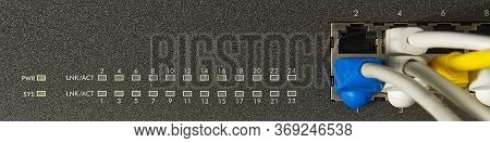 Network Switch And Ethernet Cable In Rack Cabinet. Network Connection Technology Thrue Cat6 And Cat5