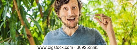 Man Placing A Bite Plate In His Mouth To Protect His Teeth At Night From Grinding Caused By Bruxism 