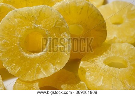 Dried Pineapple Candy Rings, Close-up. Yellow Pineapple Sweets Cut In Round Slices In Powdered Sugar