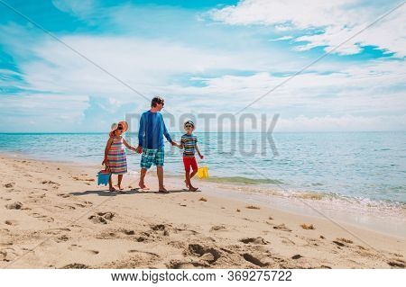 Father With Son And Daughter Walking On Beach, Family Summer Vacation