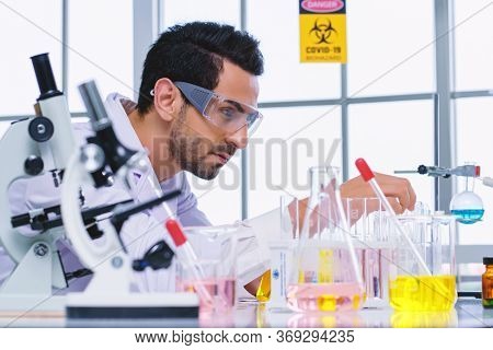 Doctor And Microbiologist With Vacuum Tubes For Samples With Covid 19 Infection Atypical Pneumonia V