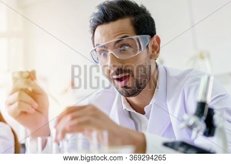 Doctor And Microbiologist With Vacuum Tubes For Samples With Covid 19 Infection Atypical Pneumonia V