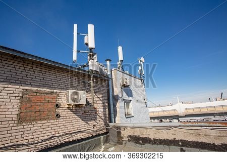 Russia, Saint-petersburg - April 30, 2018: Panel Antenna Of 5g, 4g, 3g, 2g Bands, Optical Fibers, Po