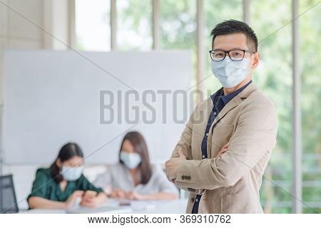 Business Employees Wearing Mask During Work In Office To Keep Hygiene Follow Company Policy.preventi