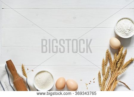 Baking Background With Flour, Wheat Ears And Rolling Pinon Concrete Background. Top View With Copy S