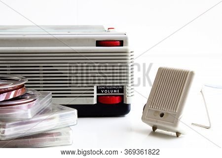 old tape recorder with magnetic tapes with recordings on white background