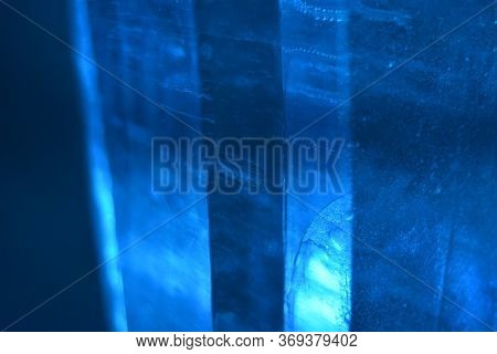 Bubbles Are Trapped Within These Columns Of Blue Ice That Swim In And Out Of Focus To Give A Monochr