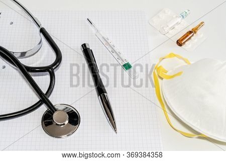 Medical Masks With Elastic Band, Thermometer, Medicine And Stethoscope, Isolated On White Background