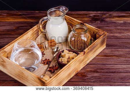 Ingredients For Dalgon Coffee In A Box On A Wooden Background. Instant Coffee, Anise, Cinnamon, Cane