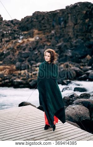 A Girl In A Red Dress Near Ehsaraurfoss Falls, Ehsarau River, National Park, Tingwedlir, Sudurland R