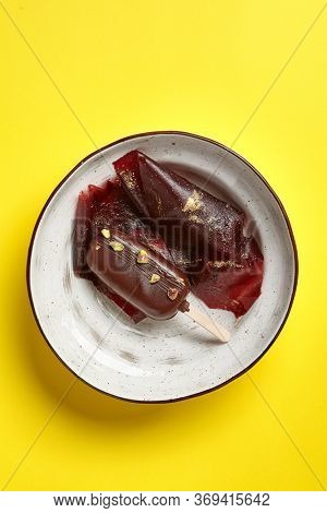 Chocolate mousse dessert top view. Luxury restaurant sweet course side view. Ice cream served with pastila in deep craft plate. Fancy confectionery dish with jellied fruit sweetmeat. Sweet food