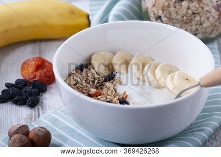 Healthy Breakfast: Raisins, Dried Apricots, Nuts, Oatmeal, Yogurt And Fresh Fruits