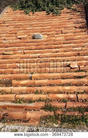 Closeup Of An Old Roof With Broken Clay Terracotta Tiles (coppo In Italian Language). Veneto, Italy,