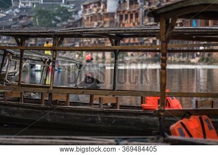Close Up Of Old Historic Wooden Tourist Boats Moored On The Riverbank Of Tuo River, Flowing Through 
