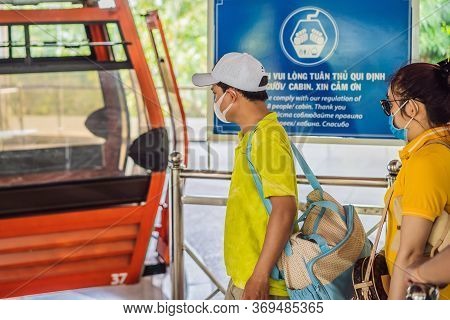 Vietnam, Nha Trang, 24.05.2020: People Wearing A Hygiene Protective Mask Over Face While Ride A Cabl