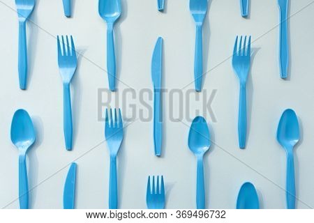 Many Blue Plasic Forks, Spoons And Knives On Light Background, Top View. Disposable Tablewear, Sorti