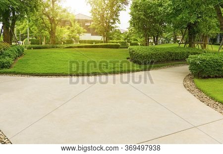Gray Curve Pattern Walkway, Sand Washed Finishing On Concrete Paving, Brown Gravel On Border, A Smoo