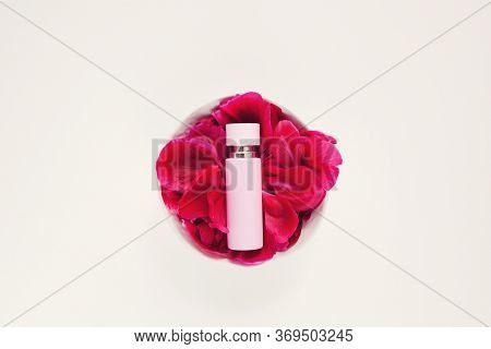 Pink Perfume Spray Bottle On Peony Petals On White Background. Copy Space For Your Text. Top View. P