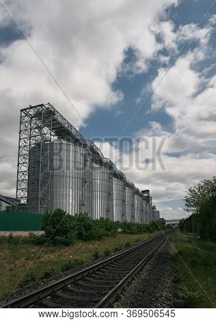 A Large Modern Plant For The Storage And Processing Of Grain Crops.  Silver Silos Granary In A Row. 