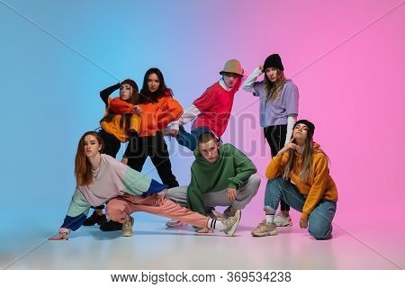 Group Of Dancers, Boys And Girls Dancing Hip-hop In Stylish Clothes On Colorful Gradient Background 