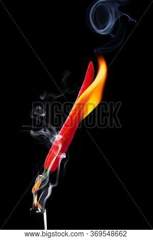 The Chilli Burned With White Smoke Floating, Showing The Hot Feeling Placed On A Black Background.