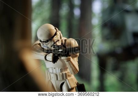 JUNE 1 2020: scene from Star Wars Return of the Jedi with an Imperial Stormtrooper firing his E-11 blaster on the forest moon of Endor - Hasbro action figure